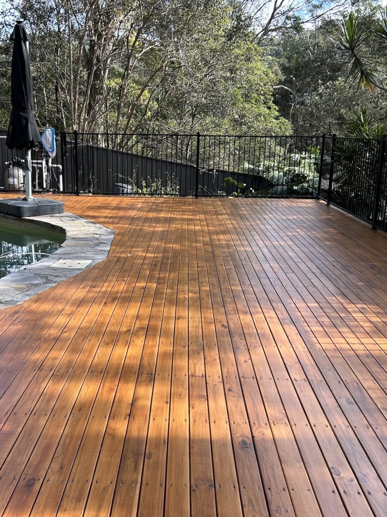 Newly stained pool side deck in Woronora which showcases the timbers grain & knots.